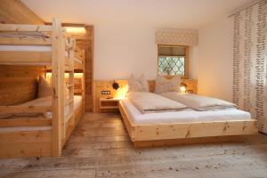 a bedroom with two bunk beds and a window at Gästehaus Trixl in Zell am See