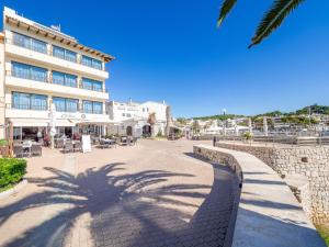 a large building with a clock on the side of it at Hostal Port Corona in Cala Ratjada
