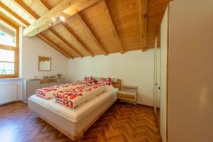 a bedroom with a large bed with red pillows at Ferienwohnungen Oberweier in Merano