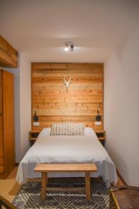 a bedroom with a bed with a wooden wall at Envalira Vacances - Woody in Pas de la Casa