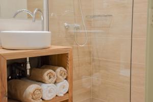 a bathroom with a shower and a sink and towels at Envalira Vacances - Woody in Pas de la Casa