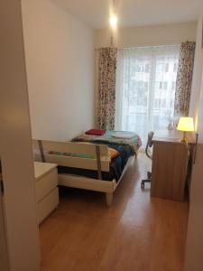a small room with two beds and a window at Glatthall in Glattbrugg