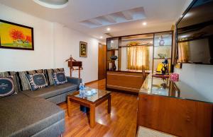 a living room with a couch and a table at Hoang Hai Hotel in Hai Phong