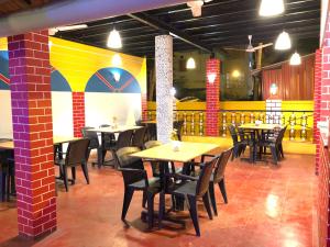 a dining room with tables and chairs in a restaurant at Casa Salvador in Calangute