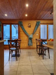 
a room with a table, chairs, and a window at Chalet Le Bois Joli in Bonneval-sur-Arc
