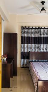 a bedroom with a bed and a curtain at EViF Home Stay in Dhaka