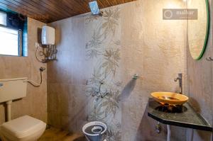 a bathroom with a sink and a toilet at Malhar Villa -Kashid in Kashid +76 photos