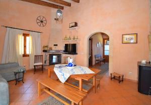 a living room with a table and a couch at Finca Estret 184 by Mallorca Charme in Santa Margalida