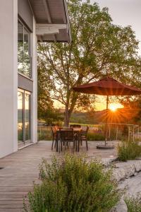 a patio with a table and an umbrella at Inspiration am See in Bad Endorf