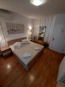 a bedroom with a bed with two pillows on it at Apartments Adria in Jadrija
