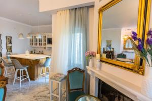 a living room with a fireplace and a mirror at Koroni Zaga Beach- Seascape Luxury Villa Costiana in Koroni