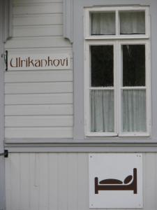 a white building with a sign on the front of it at Ulrikanhovi in Loviisa