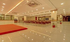 a conference room with chairs and a red rug on the floor at Treebo Trend Rainbow Grand in Visakhapatnam