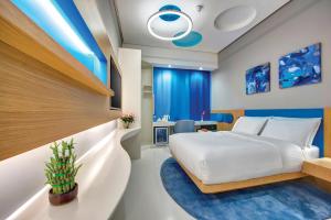 a hotel room with a bed and a desk at Al Khoory Inn Bur Dubai in Dubai