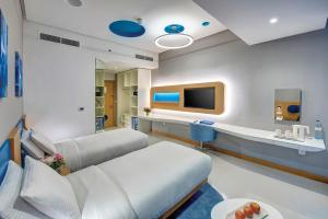 a hospital room with a bed and a tv at Al Khoory Inn Bur Dubai in Dubai