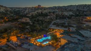 an aerial view of a resort with a pool at night at Holiday Cave Hotel in Göreme