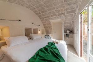 Postel nebo postele na pokoji v ubytování Masseria Borgo San Marco