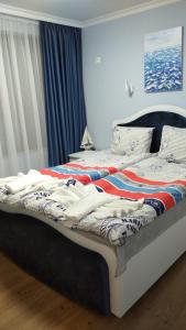 a bedroom with a bed with clothes on it at Ravda on the Beach in Ravda
