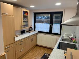 cocina con fregadero y ventana en Ferienwohnung Limes en Aalen