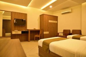 Postel nebo postele na pokoji v ubytování WHITE SUITE HOTEL