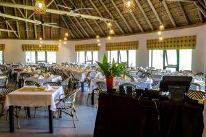 a dining room filled with tables and chairs at Cradle Moon Lakeside Game Lodge in Muldersdrift