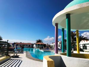 a view of a swimming pool at a resort at Casthotels Fuertesol Bungalows in Caleta De Fuste