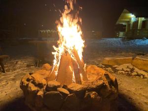 a fire pit in the snow at night at Osada Karkonoska in Kowary