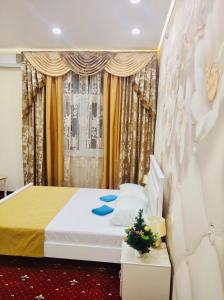 1 dormitorio con 1 cama y una ventana con cortinas en Apartment & Guest Rooms ART Bukhta, en Sevastopol