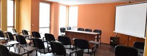 a lecture room with chairs and a white board at Хотел Дива in Blagoevgrad