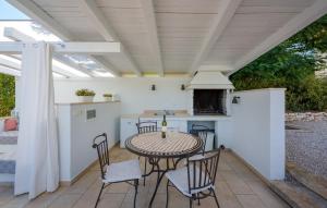a patio with a table and chairs and a stove at Villa Vigneri in Novigrad Istria