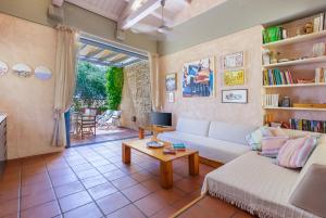 a living room with a couch and a table at Barbati Beach Art House in Barbati