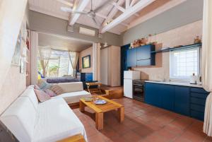 a living room with a white couch and a table at Barbati Beach Art House in Barbati