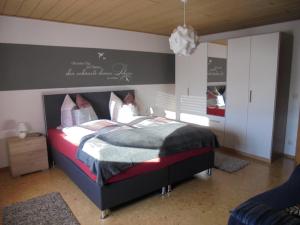 a bedroom with a large bed in a room at Ferienwohnung Haus Monika in Rötz +43 photos