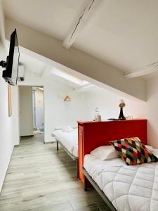 1 dormitorio con 2 camas y TV. en RESIDENZA 8, en Rávena
