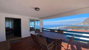 a dining room with a table and chairs and the ocean at Casa Camilo I in Valle Gran Rey