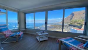 a room with a view of the ocean and mountains at Casa Camilo I in Valle Gran Rey