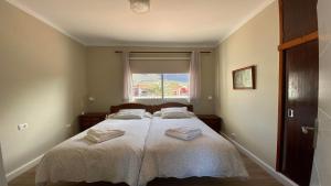 a bedroom with two beds with white sheets and a window at Casa Camilo I in Valle Gran Rey