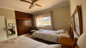 a bedroom with two beds and a ceiling fan at Casa Camilo I in Valle Gran Rey