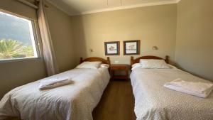 two twin beds in a room with a window at Casa Camilo I in Valle Gran Rey