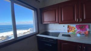 a kitchen with a view of the ocean from a window at Casa Camilo I in Valle Gran Rey