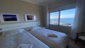 a bedroom with a large bed and a large window at Casa Camilo I in Valle Gran Rey
