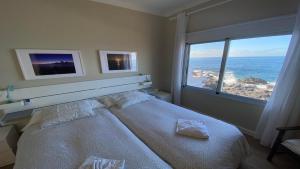 a bedroom with a large bed with a large window at Casa Camilo I in Valle Gran Rey