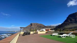 a deck with chairs and a view of the ocean at Casa Camilo I in Valle Gran Rey