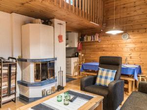 a living room with a fireplace and a table at Holiday Home Nurmennunnu by Interhome in Levi