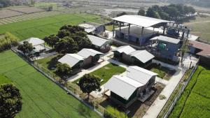 an aerial view of a large house with white roofs at Sukoon - A Wellness Resort, Uttarakhand in Chūharpur