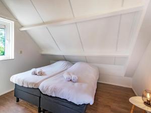 a room with a bed with two pillows on it at Holiday Home Citta Romana-1 by Interhome in Hellevoetsluis