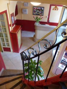 a spiral staircase in a building with a lobby at Hôtel de Provence in Brignoles