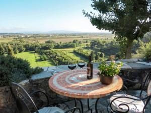 a table with two glasses of wine on a patio at Holiday Home Maestraccio by Interhome in Buti