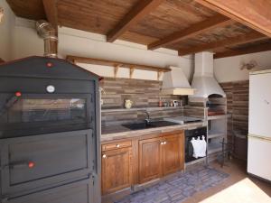 a large kitchen with a stove and a sink at Villa Eureka by Interhome in Solarino
