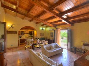 a living room with couches and a table and a kitchen at Villa Eureka by Interhome in Solarino